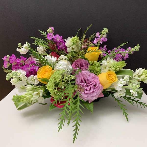 Mixed bouquet with pink, yellow, and white flowers on a table