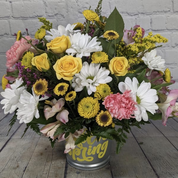Yellow roses and white daisies in a metal bucket