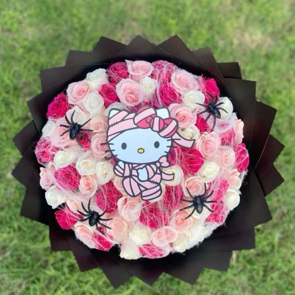 Round bouquet of pink and white roses with a Hello Kitty topper