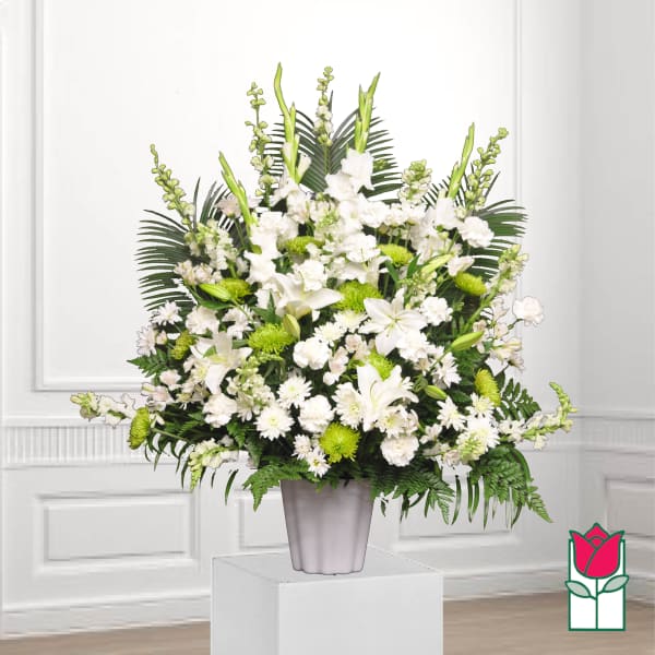 White floral arrangement in a gray vase with green accents