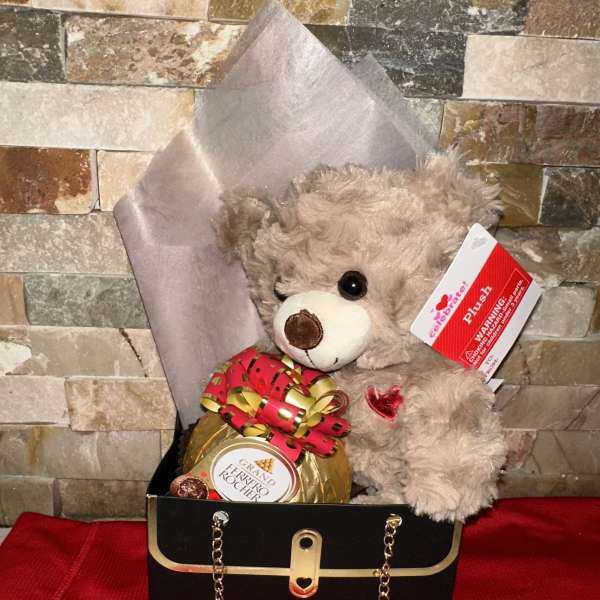 Teddy bear in a gift box with a Ferrero Rocher chocolate and ribbon