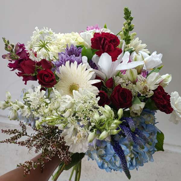 Mixed bouquet of red, white, purple, and blue flowers