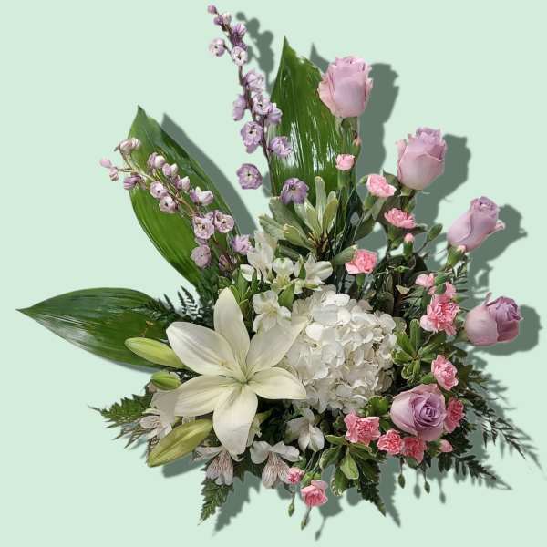 Lavender roses, white lilies, and white hydrangea in a mixed bouquet