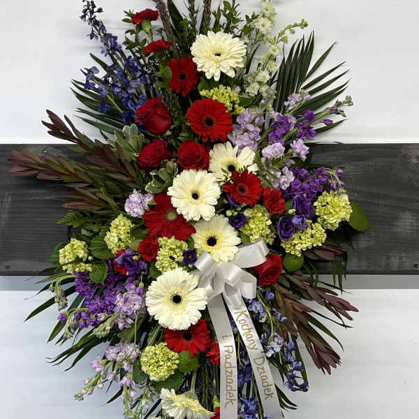 Large standing floral spray with red, white, purple, and blue flowers