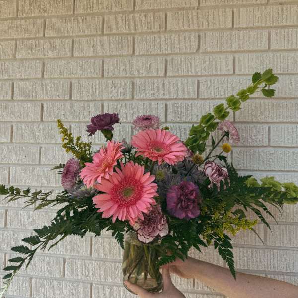 Pink and purple mixed bouquet in a glass vase