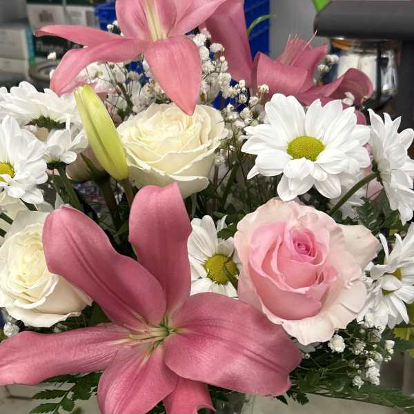 Bouquet of pink lilies, roses, and white daisies