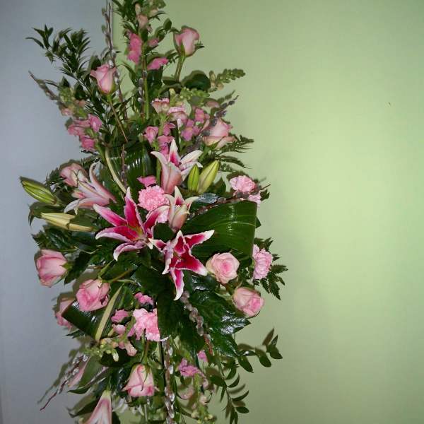 Tall pink and white floral standing spray with lilies and roses
