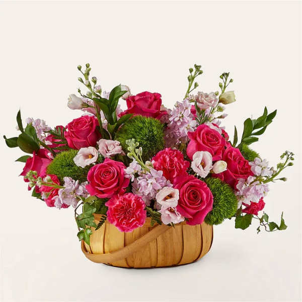 Pink roses and carnations in a woven basket
