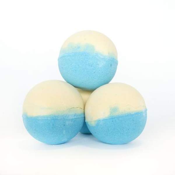 Three blue and cream bath bombs stacked on a white background