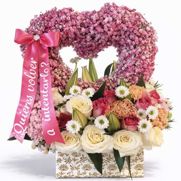 Heart-shaped pink floral arrangement with roses and a ribbon in a patterned box