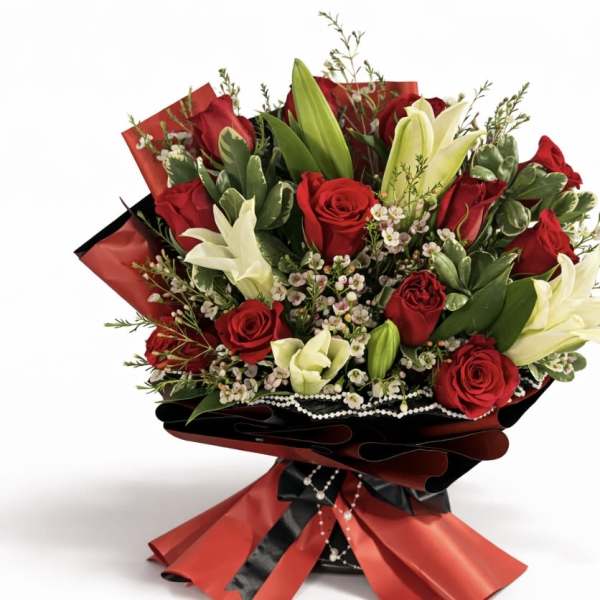 Bouquet of red roses and white lilies wrapped in red and black paper