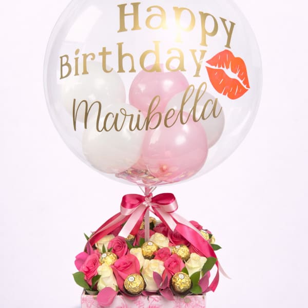 Birthday balloon over pink and white roses with chocolates in a floral box