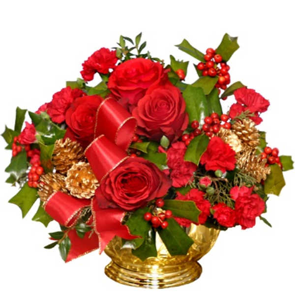 Red roses and carnations with holly, red ribbon, and gold pinecones in a gold bowl.