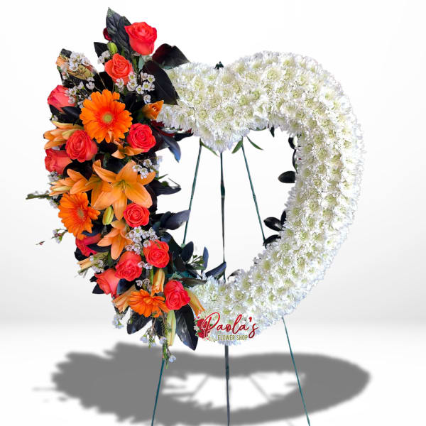 Heart-shaped floral standing spray with orange and red flowers