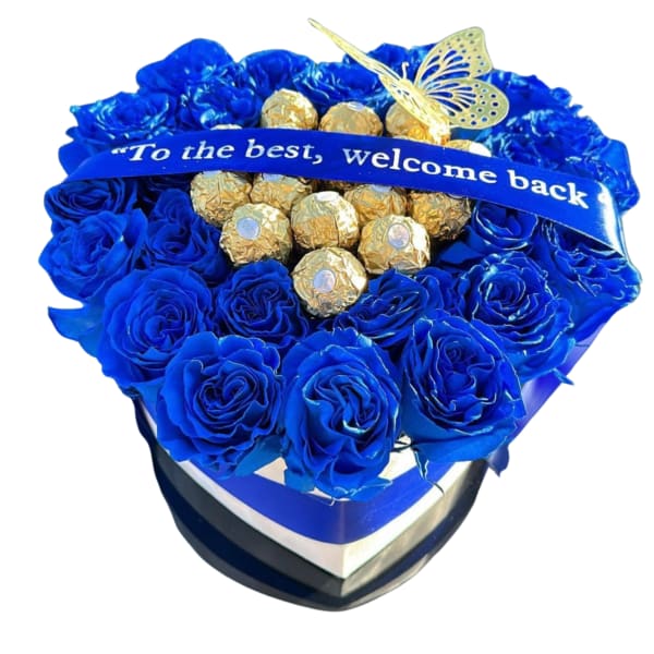 Blue rose arrangement with gold-wrapped chocolates and a ribbon