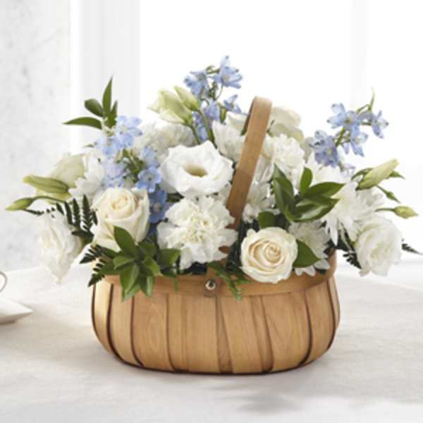 White and blue flowers arranged in a woven basket