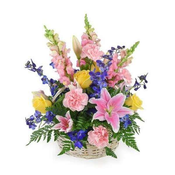 Basket arrangement of pink lilies, yellow roses, and blue flowers