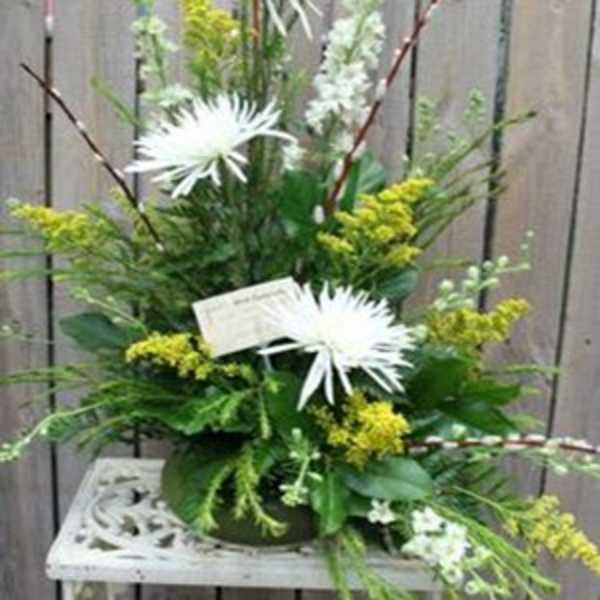 White spider mums in a mixed green floral arrangement