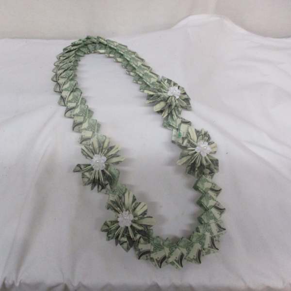 Dollar bill lei with small white flower accents