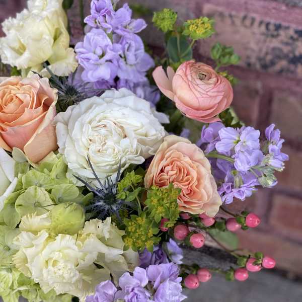 Bouquet of peach and white roses with lavender flowers