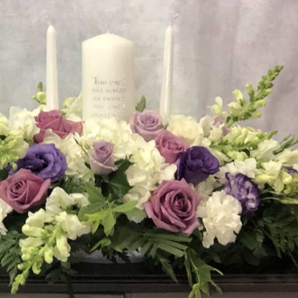 Lavender and white floral casket spray with candles