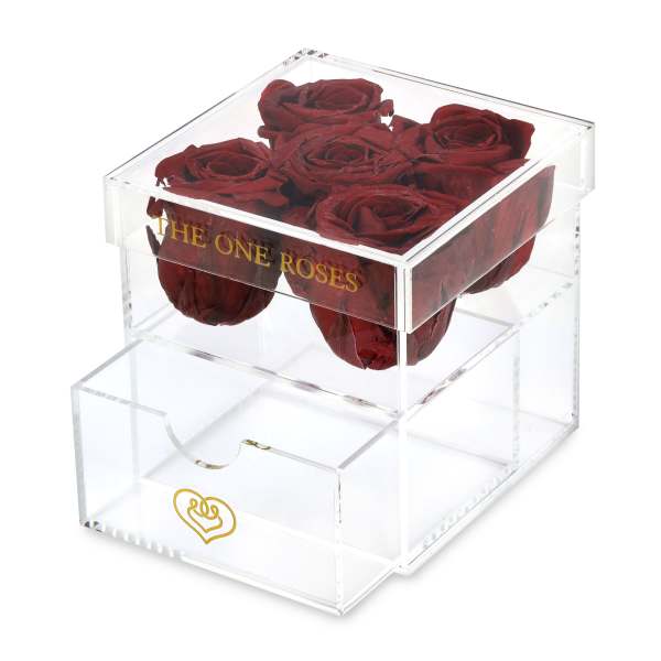 Clear acrylic box holding dark red roses