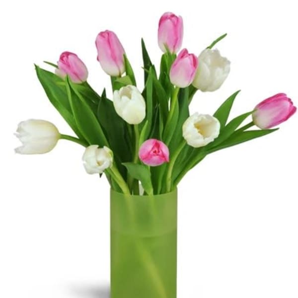 Pink and white tulips arranged in a green vase