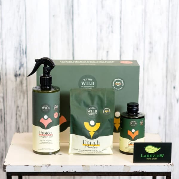 Plant care gift set with spray bottle, pouch, and bottles on a table