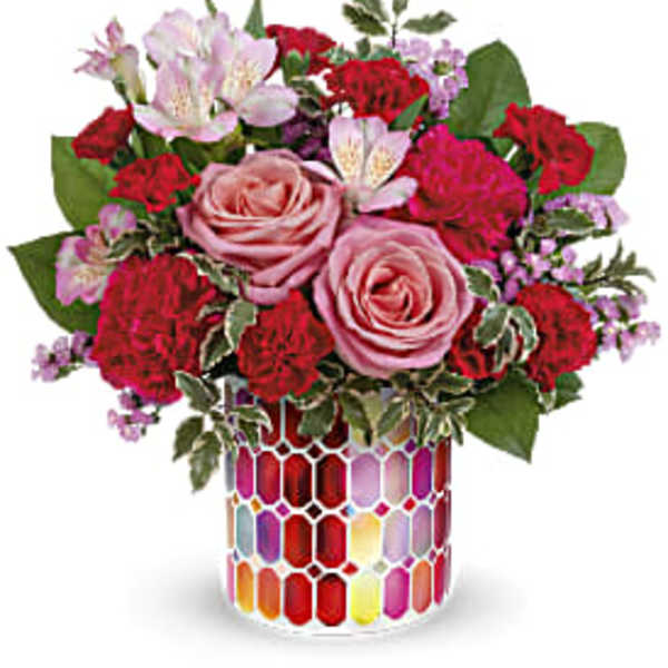 Pink and red mixed flower bouquet in a colorful mosaic vase