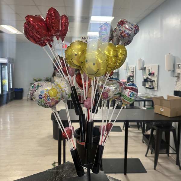 Cluster of helium balloons on sticks in a display stand