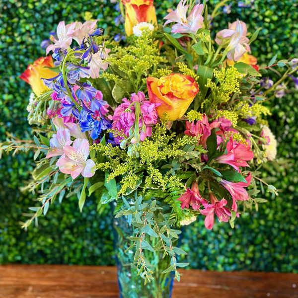Colorful mixed bouquet in a blue glass vase