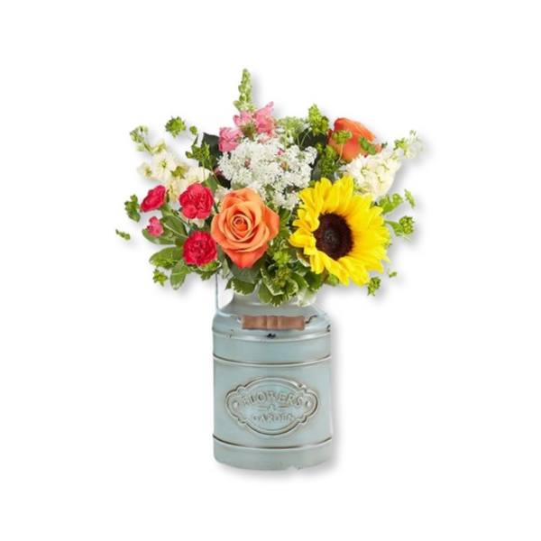 Mixed bouquet with a sunflower, roses, and a blue metal vase