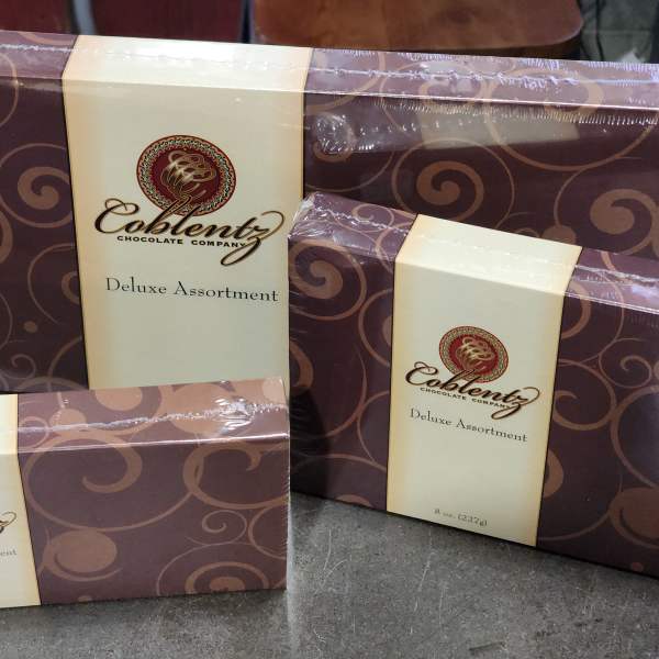 Three boxed assortments of chocolates with brown and cream packaging