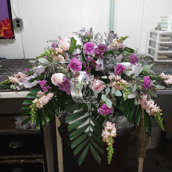 Large pink and lavender floral spray with ribbon and greenery