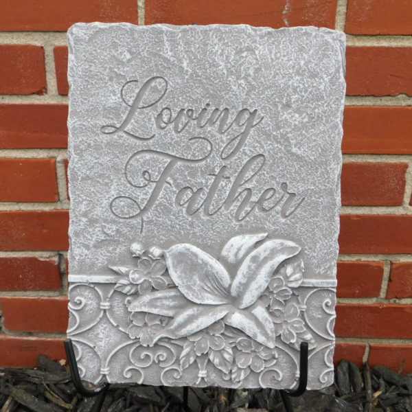Decorative stone plaque reading "Loving Father" with floral relief
