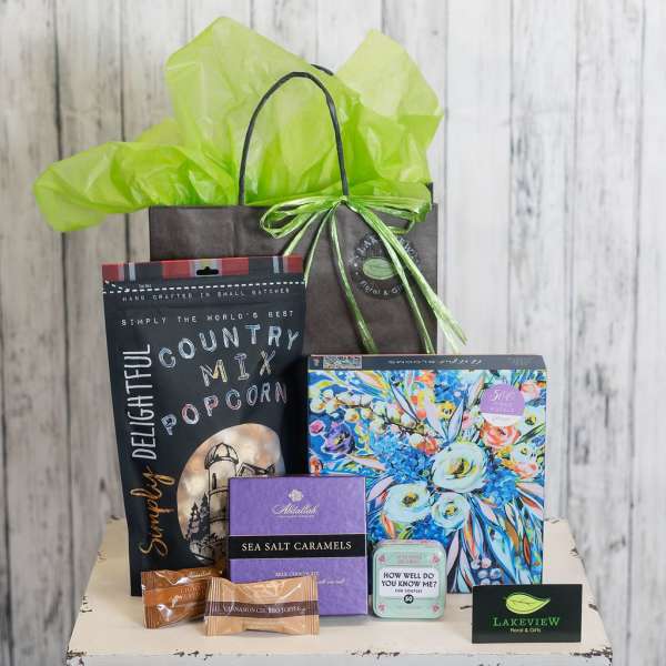 Gift bag with popcorn, candy, puzzle, and small game items