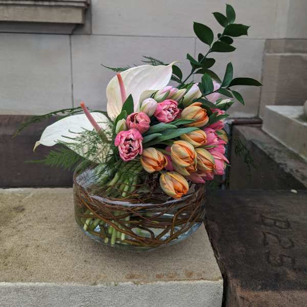 Tulip and anthurium arrangement in a glass bowl vase