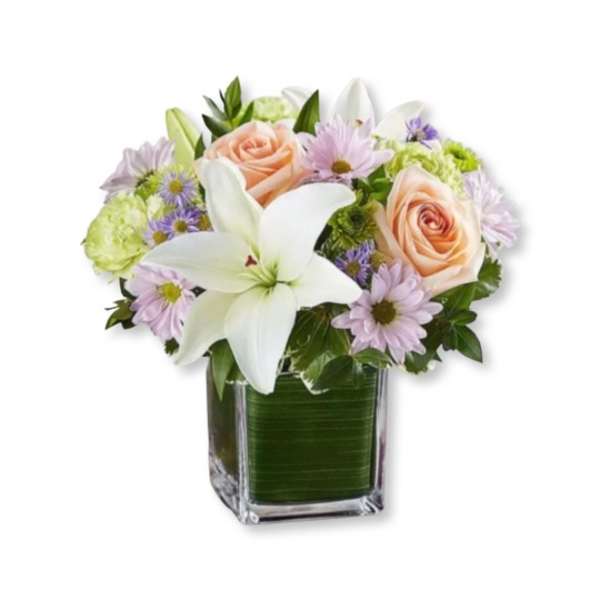 Bouquet of white lilies, peach roses, and lavender daisies in a glass vase