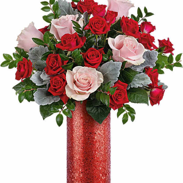 Red and pale pink roses in a tall red vase