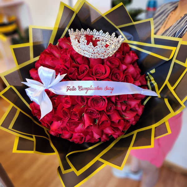 Bouquet of red roses with a silver crown and white ribbon