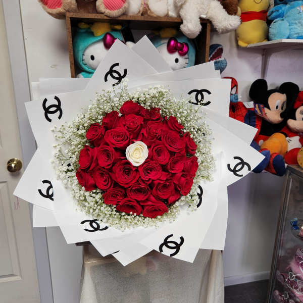 Bouquet of red roses with a white rose center and white baby's breath
