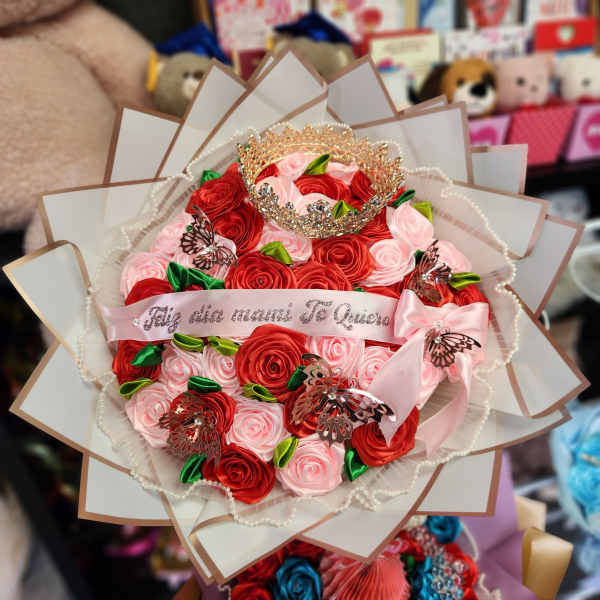 Bouquet of red and pink roses with a jeweled crown and ribbon