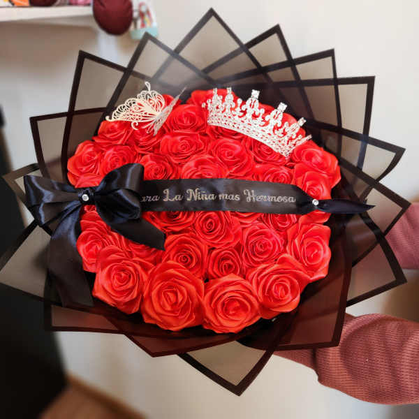 Red rose bouquet with black wrap, ribbon, and decorative crowns