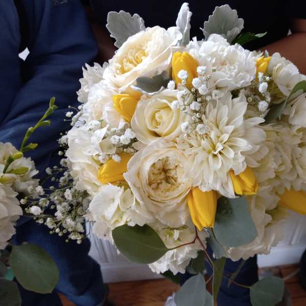 Bouquet of white and yellow flowers with soft gray-green foliage