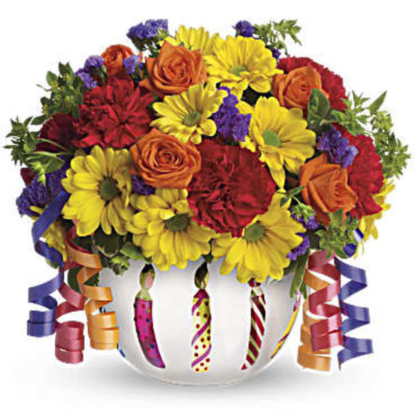 Colorful bouquet of roses and daisies in a white vase with curling ribbons