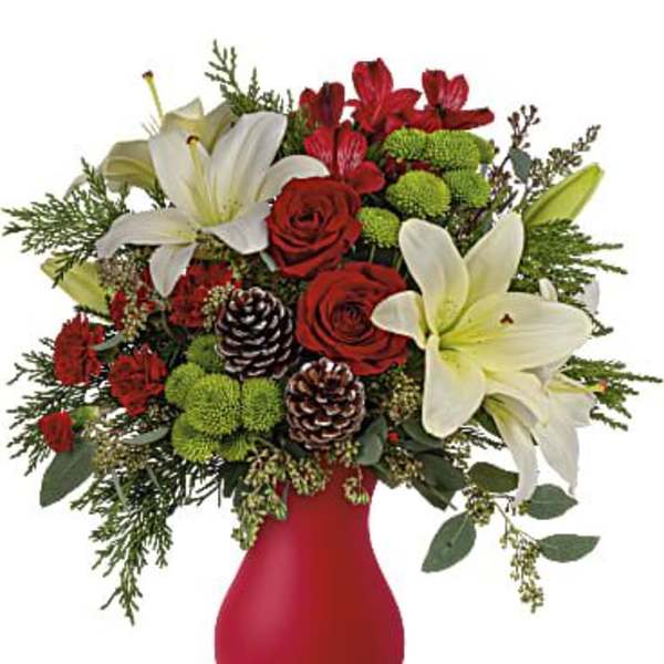 Red and white floral arrangement in a red vase