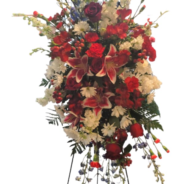 Tall standing floral spray with red, white, and burgundy blooms
