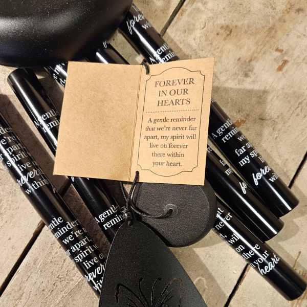 Black memorial candles with a sympathy tag and butterfly ornament