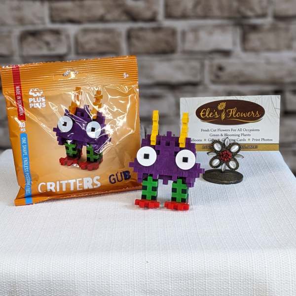 Toy building-block critter and its orange packaging on a table