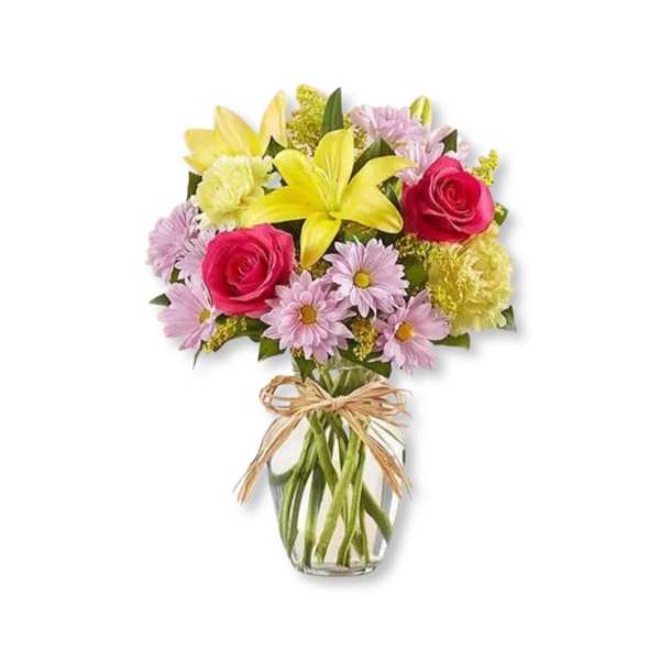Bouquet of yellow lilies, pink roses, and daisies in a glass vase